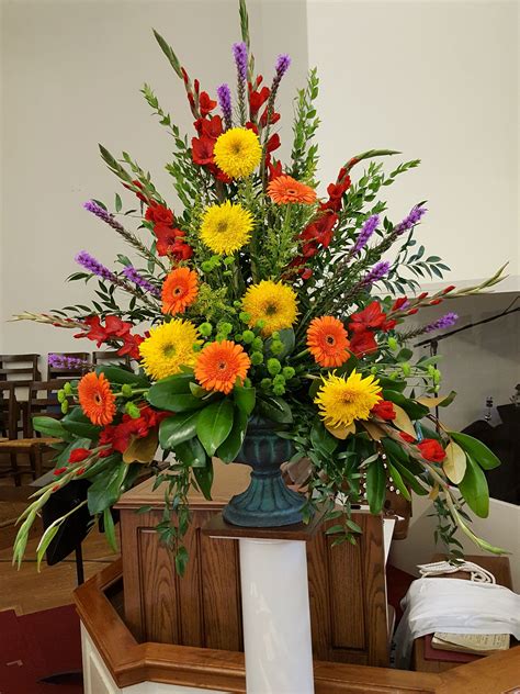 vase filled  lots  colorful flowers  top   wooden table