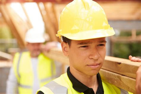 builder  apprentice carrying wood  construction site working