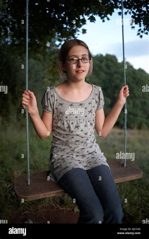 An Eleven Year Old Girl Sits Innocently On A Holiday Swing In Little