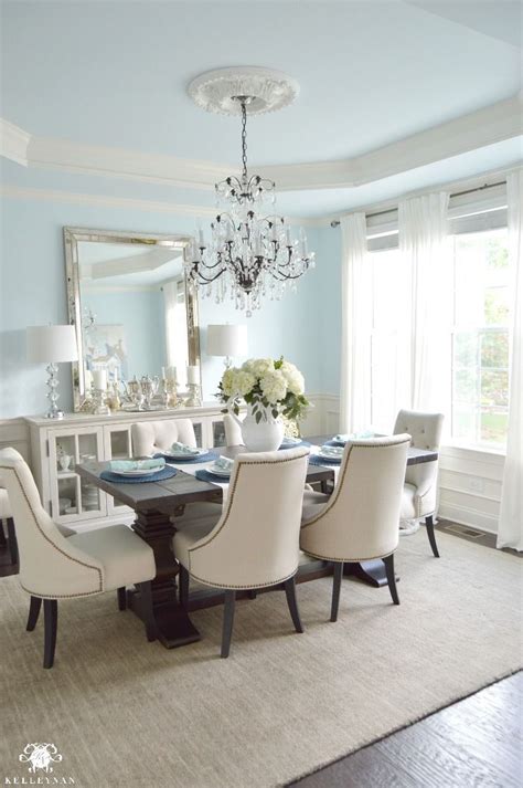 blue elegant dining room  white hydrangeas  vertical mirror