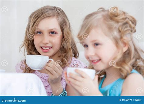 studio shot  happy  girls drinking tea stock image image