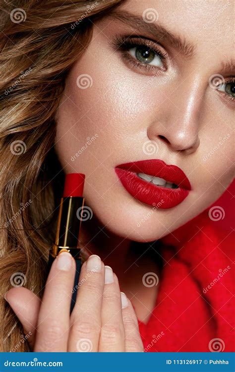 red lips beautiful woman  beauty makeup holding lipstick stock