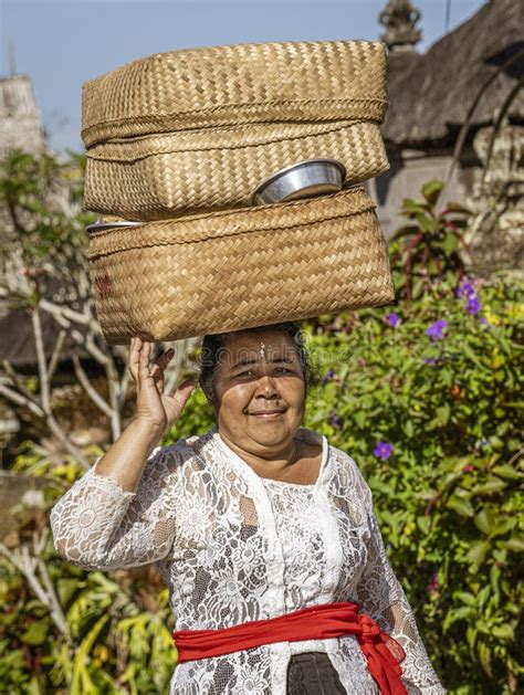bali indonesia june 1 2022 woman carries basket on her head as she