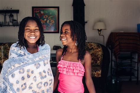 laughing african american girls in swimsuit by gabriel gabi bucataru