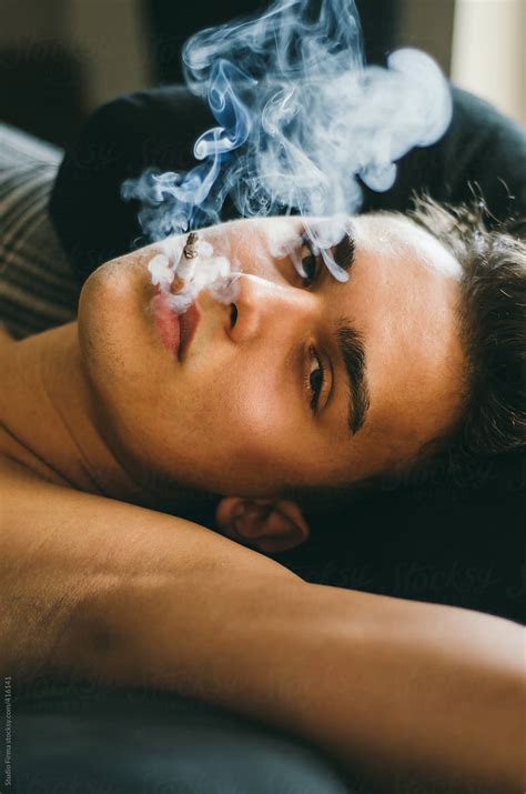 young man smoking  cigarette  stocksy contributor studio firma