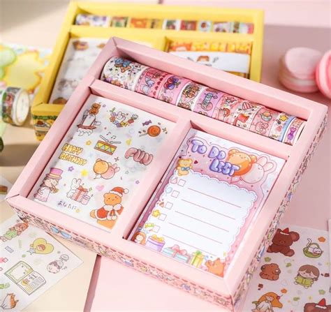 pink wooden box filled  lots  stickers  writing paper  top
