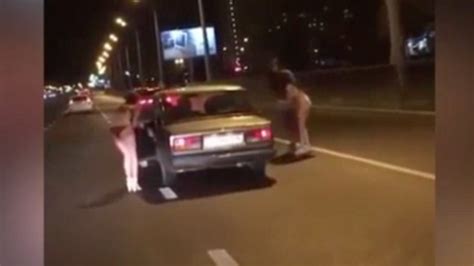 russian women strip to underwear on motorway and beg for money to find