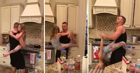 Dad Dances With His Daughter While Cooking In The Kitchen