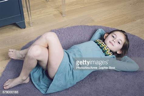 girl lying on floor with hands behind head smiling bildbanksbilder