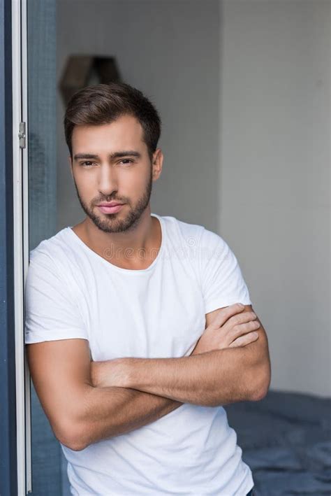young attractive man posing  arms crossed stock photo image