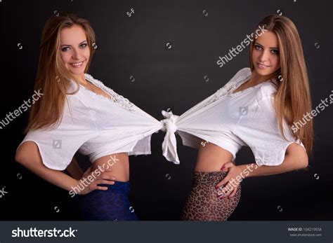 two beautiful girls twins isolated on the grey background