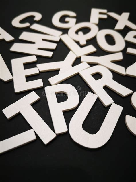 closeup image  wooden white alphabet letters  black color