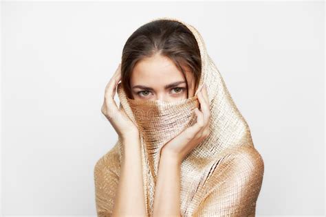 girl   golden scarf covers face ethnicity religion makeup stock