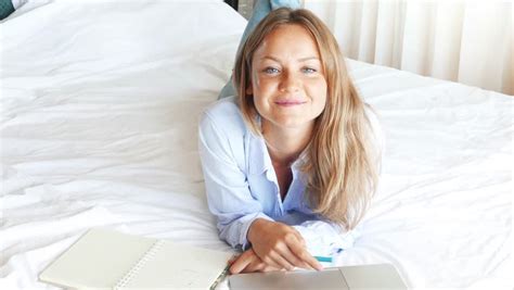 happy blonde model making a phone call lying on her bed stock footage video 4615313 shutterstock