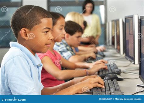 elementary students working  computers  classroom stock image