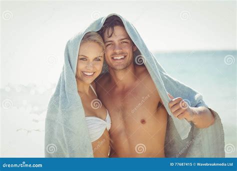 happy couple covering  heads  towel stock image image