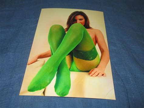 close up of stunning brunette cougar model posing in green pantyhose