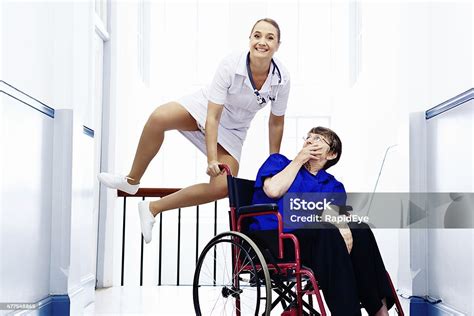 Smiling Nurse Leaps Over Amazed Elderly Patients Wheelchair Lifes Fun