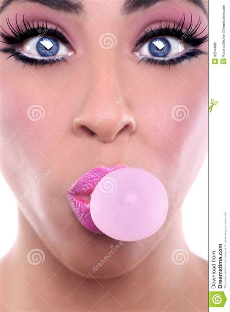 Woman With Pink Make Up Blowing Pink Bubblegum Bubble Stock Image