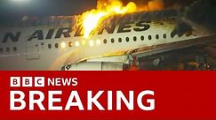 Japan Airlines plane in flames on the runway at Tokyo's Haneda Airport -BBC News