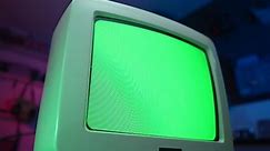Green screen is shown on an old CRT TV screen from the 1990 1980.