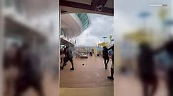Watch cruise passengers flee flying lounge chairs, debris as storm hits