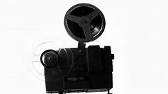 silhouette of old projector showing film