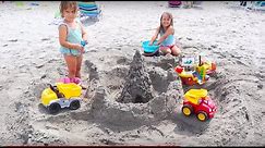 Kids playing on the beach. Making a HUGE sand castle.