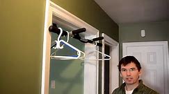 A bar for hanging clothes to dry in a door frame