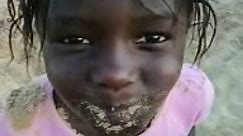 African girl eats sand