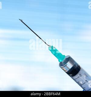 Syringe with needle on blur background Stock Photo - Alamy