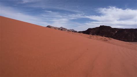 Walking Downhill From The Sand Dune With Mountains and Sand Grass ...