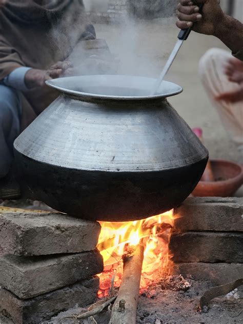 Rustic Outdoor Cooking with Open Fire and Pot · Free Stock Photo