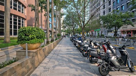 Clean sidewalks and neatly parked scooters define modern China streets