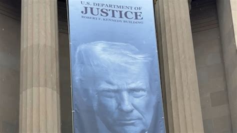Trump banner at DOJ sparks public divide