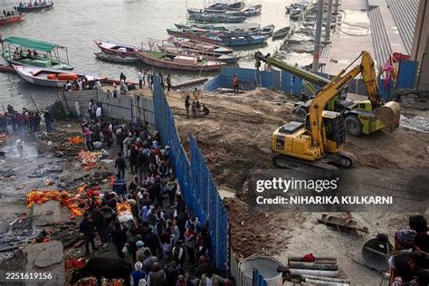 Relatives carry the deceased for funeral rites as construction work ...