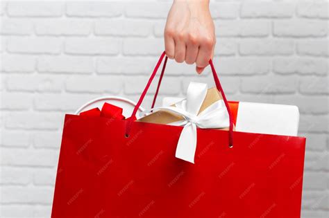 Hand holding paper bag | Premium Photo