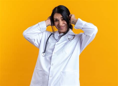 Annoyed young female doctor wearing medical robe with stethoscope ...
