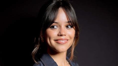 Download Jenna Ortega Smiling Portrait Wallpaper | Wallpapers.com