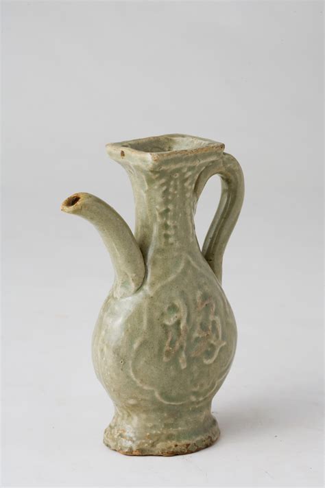 A Molded Longquan Celadon 'Fu Shou' Ewer, Ming Dynasty For Sale at 1stDibs