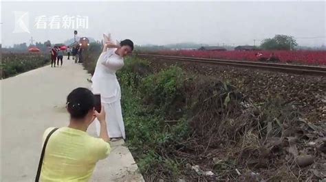 两男子铁轨上与火车玩“创意拍照” 专家提醒当心列车“吸人”