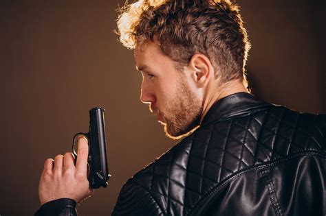 Guy holding gun Images - Free Download on Freepik