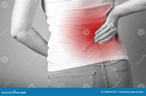 Backache. Woman Holding Painful Lower Back with Red Point Closeup. Sport, Household Injury ...