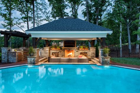 Pool cabana with custom fireplace and wood storage boxes. Including an ...