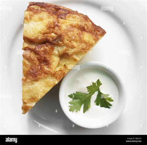 Spanish omelette with sour cream in a restaurant Stock Photo - Alamy