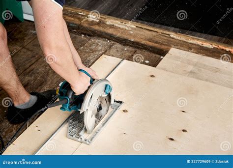 Sawing Plywood by Circular Saw. Home Repair. Hand Tool. Man Hold ...
