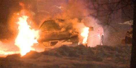 Car stuck in snow becomes engulfed in flames
