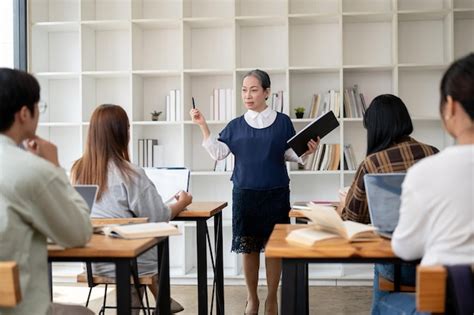 A professional mature asian female teacher teaching students in the ...
