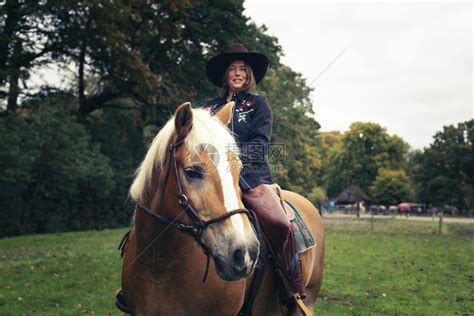 微笑的西式女人在农村骑马高清图片下载-正版图片503534316-摄图网