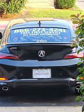 Acura loaner car parked in a dealership service bay, showcasing a clean and professional environment.